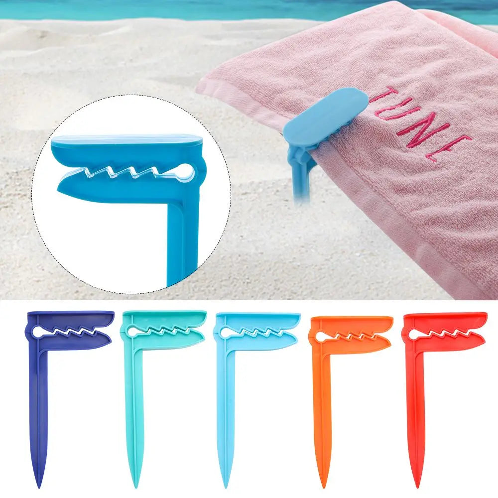 Pince à serviette de plage en plastique coloré sur sable